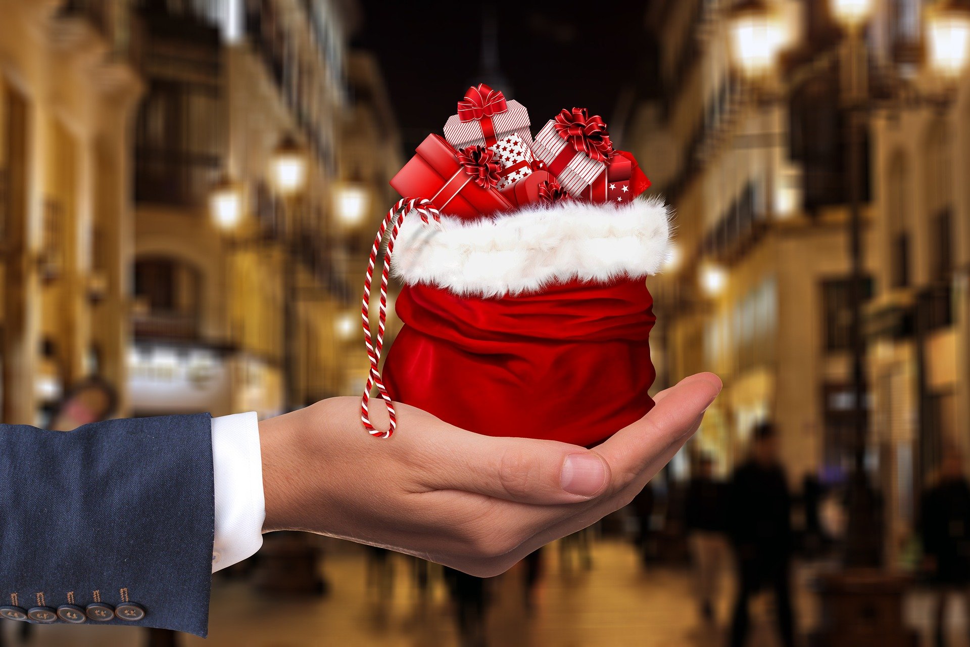 Hand holding sack of Christmas presents